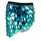 Teal sequin mini skirt featuring diamond-shaped metallic scales, a black elastic waistband, and chain-link detailing.