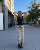 White sheer lace see-through maxi skirt with black trim, worn by a model outdoors.