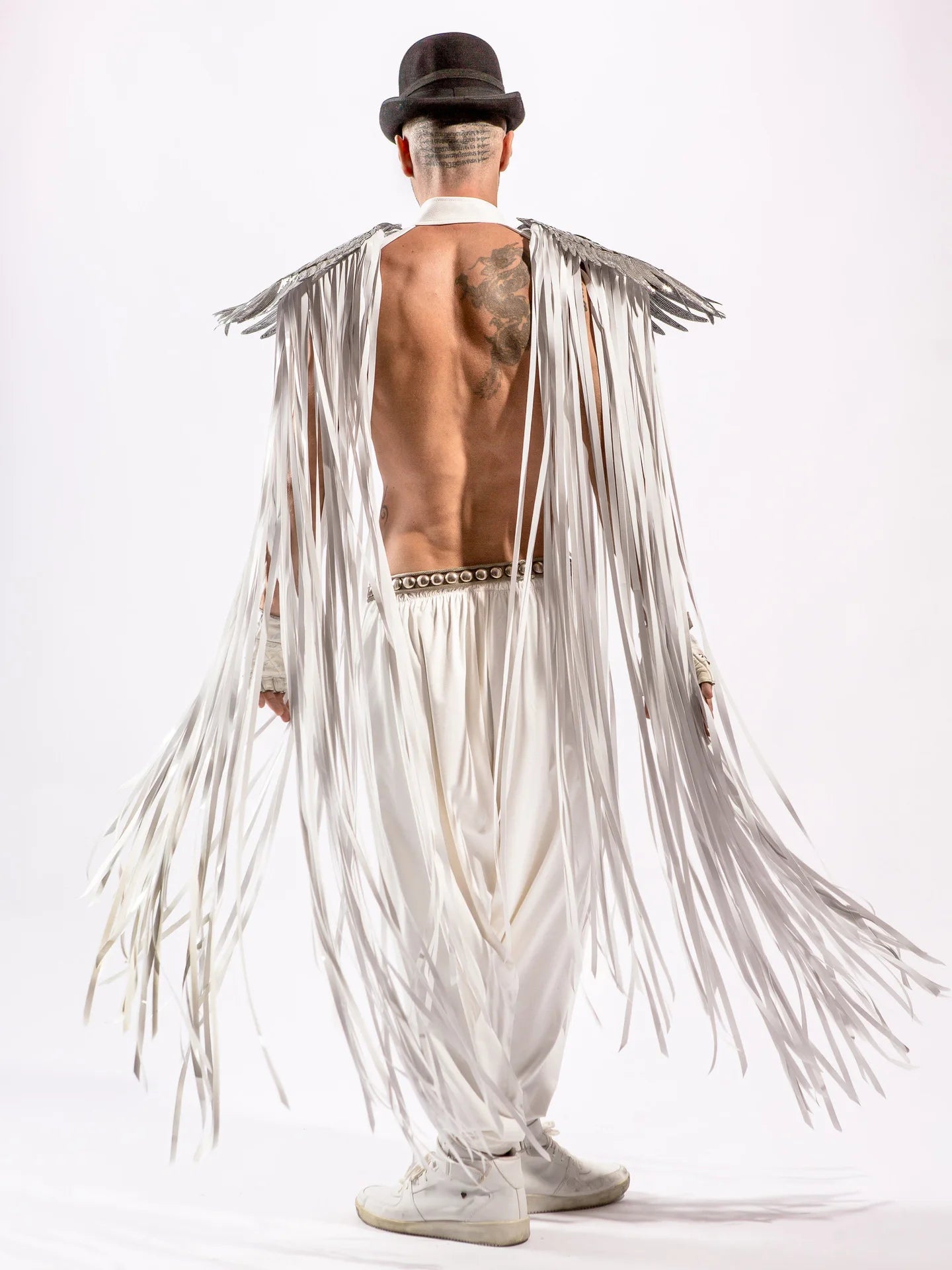 Stylish model wearing Cosplay Long Tassel Wings with flowing white tassels and a top hat.
