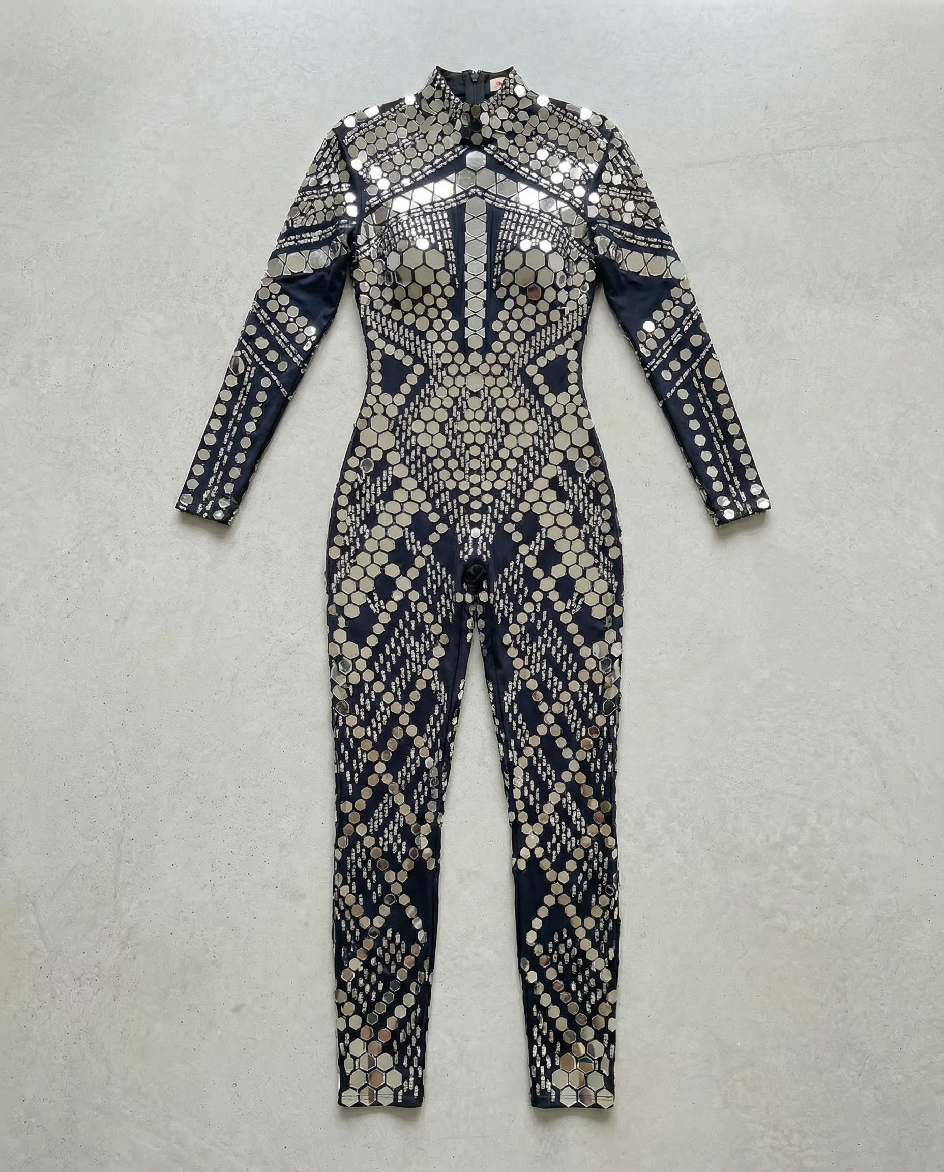 Black sequin jumpsuit with silver rhinestone accents, long sleeves, and a high neckline.