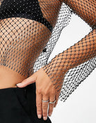 Model wearing a Diamond Mesh Long Sleeve Top featuring a sheer design and diamante detailing.